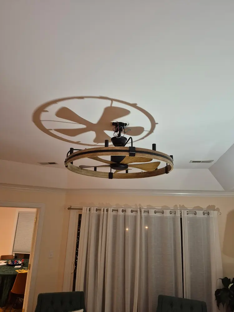 Rustic wagon-wheel ceiling fan installed and running