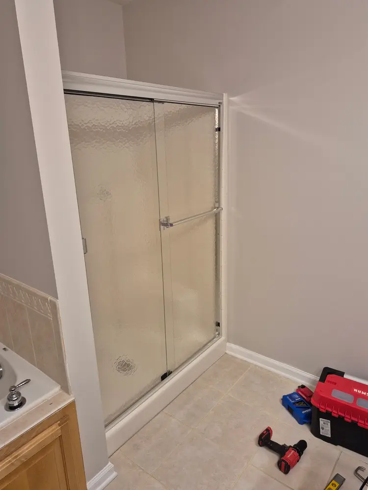 Sliding glass shower door installed and sealed