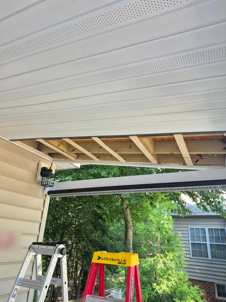 Vinyl soffit panels going in run by run